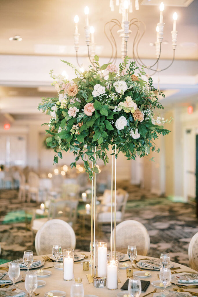 wedding table centerpiece with greenery, pink & white flowers, in hotel ballroom